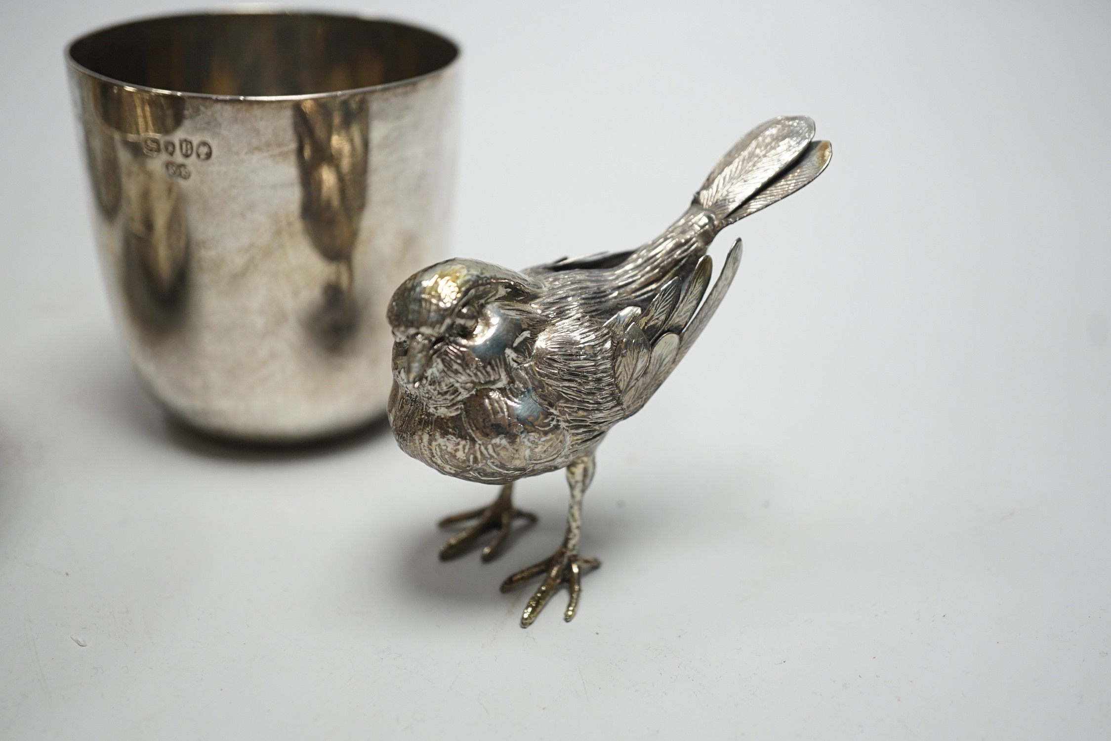 A Victorian silver tumbler cup, by Frederick Elkington, London, 1877, height 72mm, together with a silver mounted glass jar (lacking cover), a small silver bowl and an 800 white metal free-standing miniature model of a b